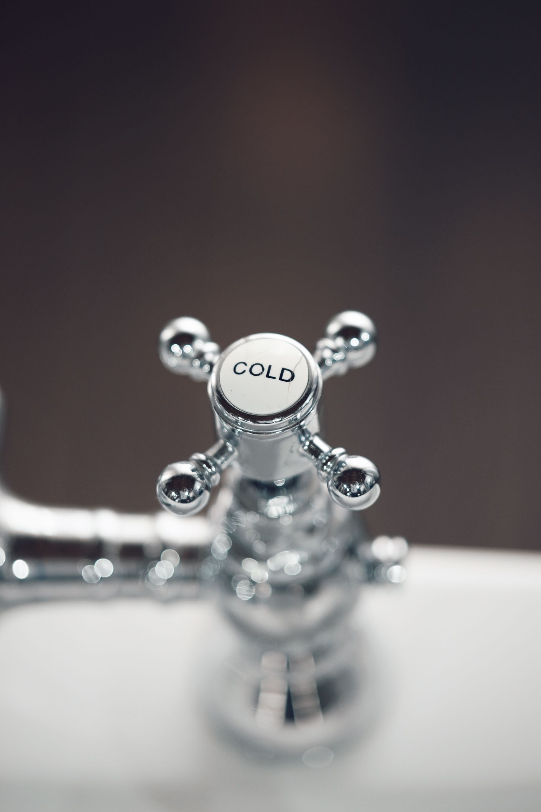 Chrome cold water tap close-up